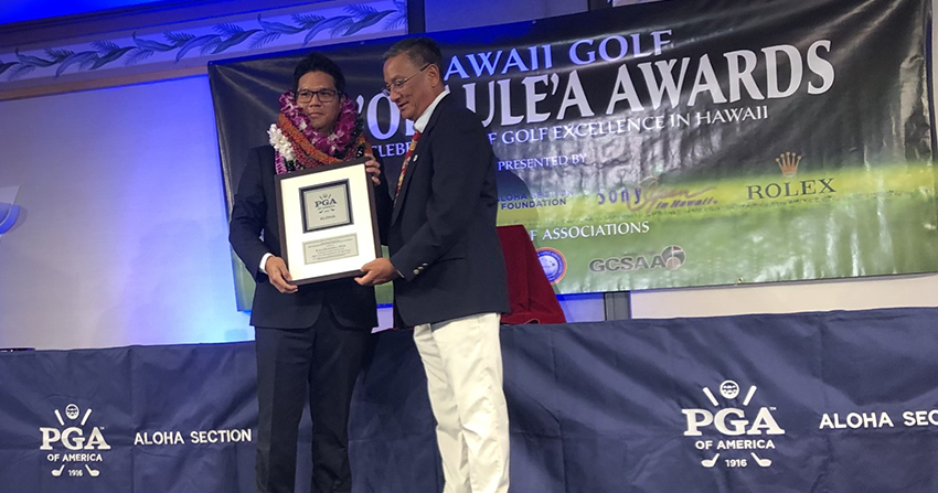 Kyle Kunioka onstage accepting award at Hoolaulea