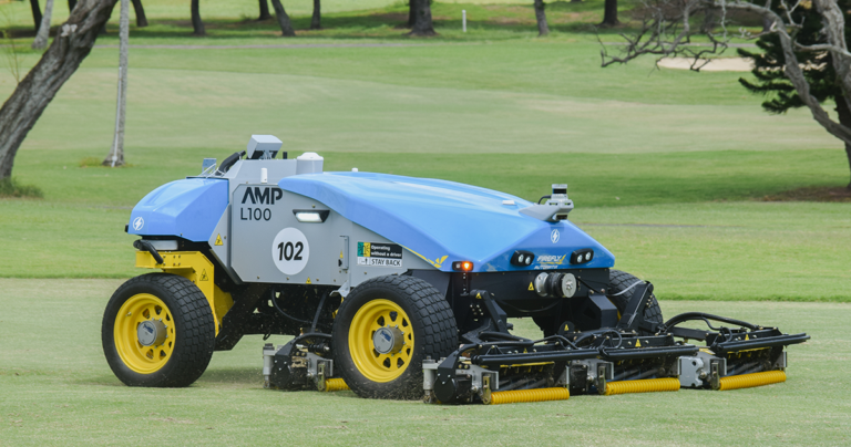 Blue and grey FireFly Autonomous Golf Course Mower pictured on the fairways of Mic-Pacific Country Club