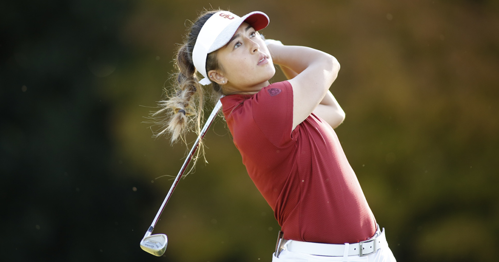 Malia Nam at the end of her swing, eyes following the ball