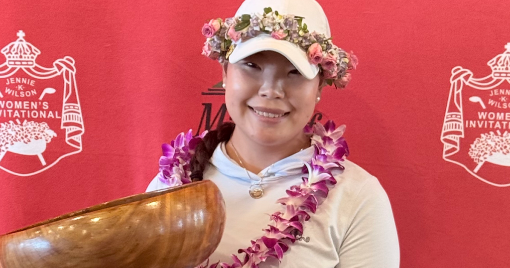 Jennie K. Wilson Invitational winner Chloe Jang holding the trophy against a red backdrop
