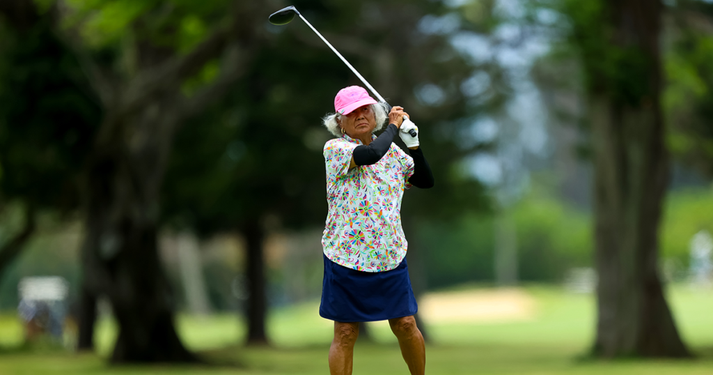 Woman watches her ball as it sails down the fairway at Mid-Pacific Country Club