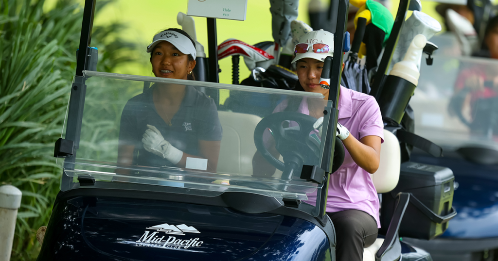Women golfers set off for tournament in golf cart at Mid-Pacific Country Club tournament